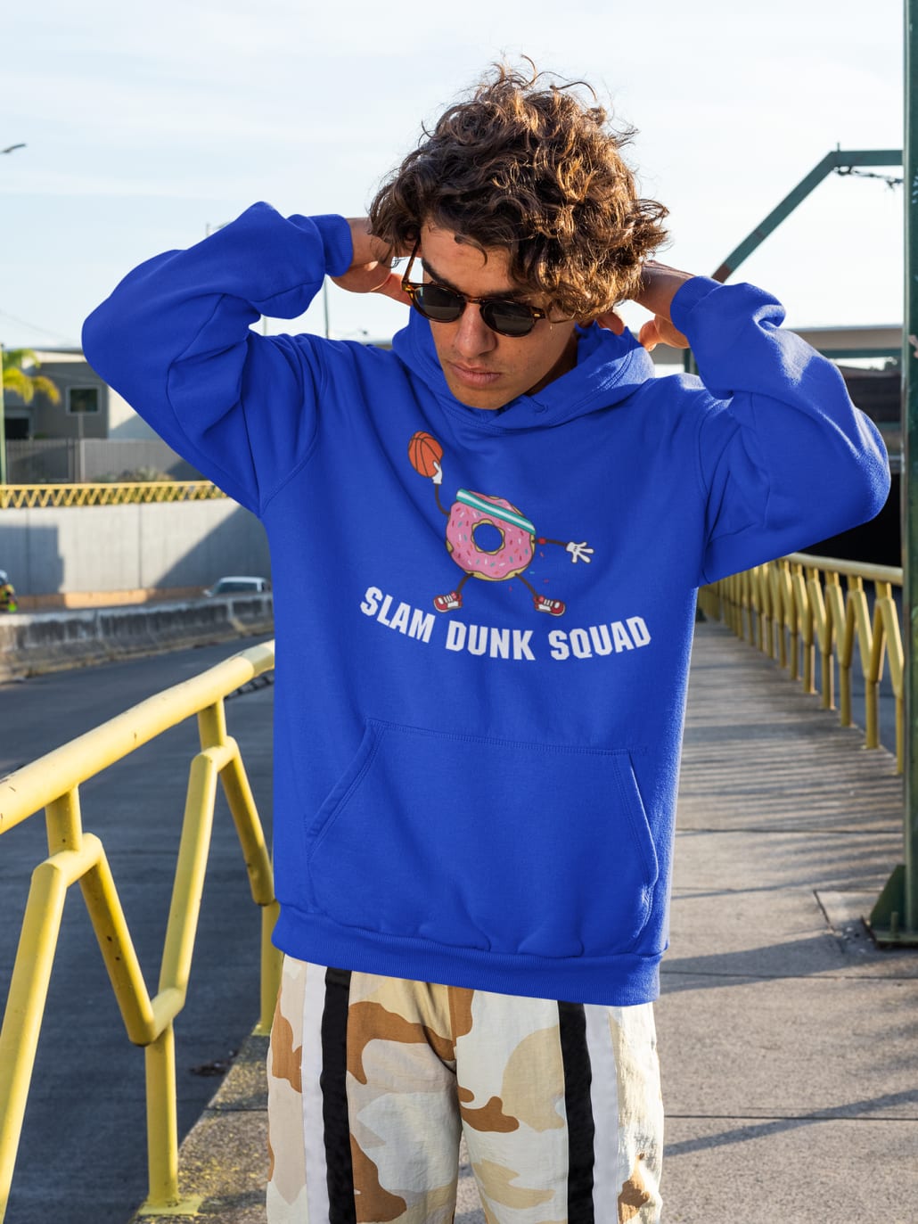 young man with sunglasses and blue sweater